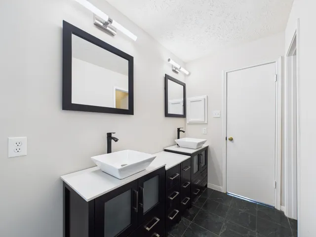 a bathroom with a double vanity sink mirror and