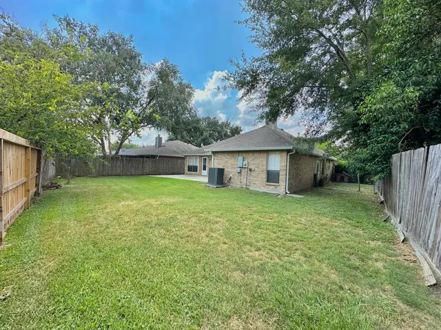 a front view of a house with a garden and yard