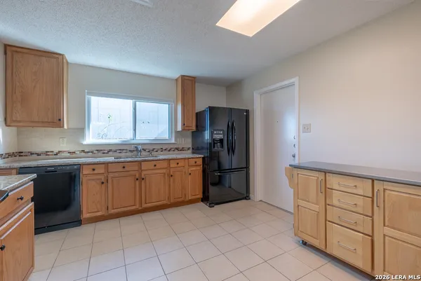 a kitchen with granite countertop cabinets and steel stainless steel appliances