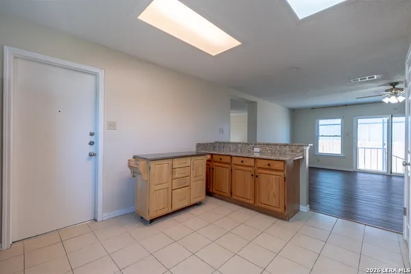 a kitchen with granite countertop a sink and cabinets