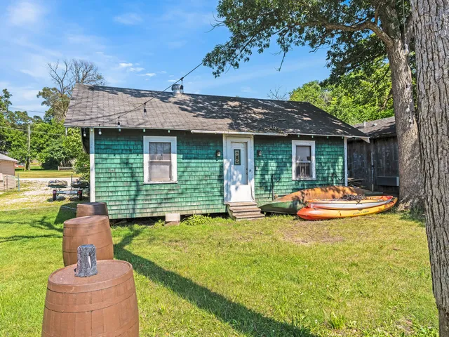 a view of a house with backyard and sitting area