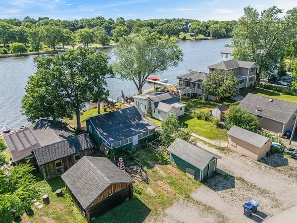 an aerial view of a house with swimming pool and lake view