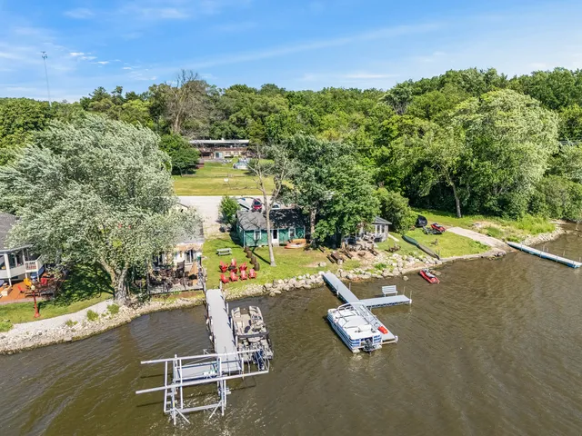 an aerial view of a swimming pool with lounge chairs