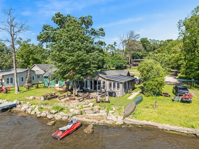 an aerial view of a house with a garden and trees
