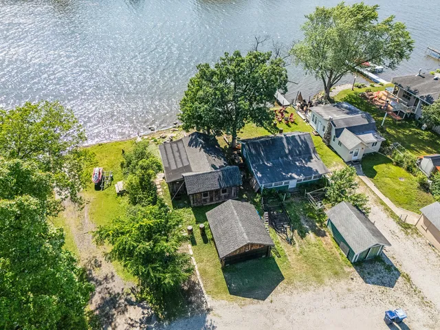 an aerial view of a house with a yard basket ball court