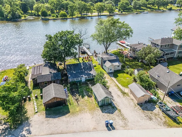 an aerial view of a house with outdoor space and lake view