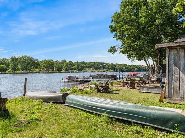 a view of a lake with couches chairs