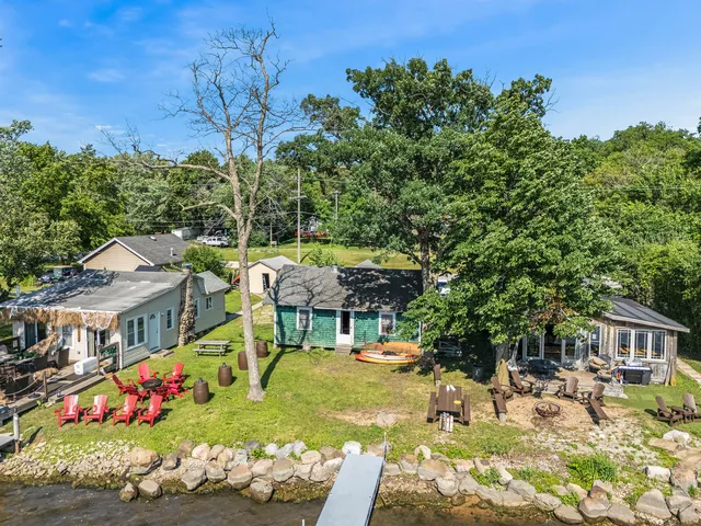 a view of a house with yard and sitting area