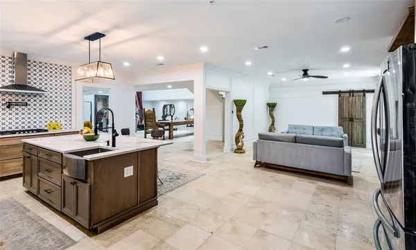 a kitchen with stainless steel appliances granite countertop a sink and a stove