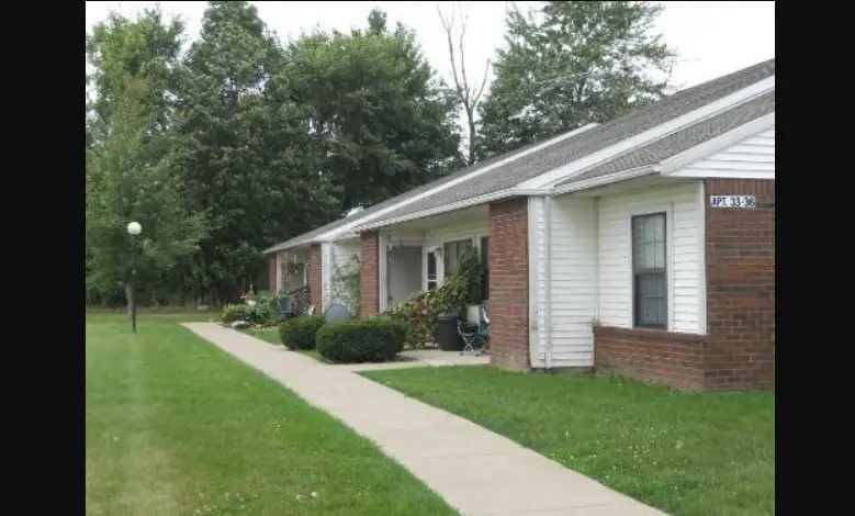 8 Senior Drive Greenwich, OH 44837 - Photo 2 of 7 a view of a yard in front of a house with plants and large tree