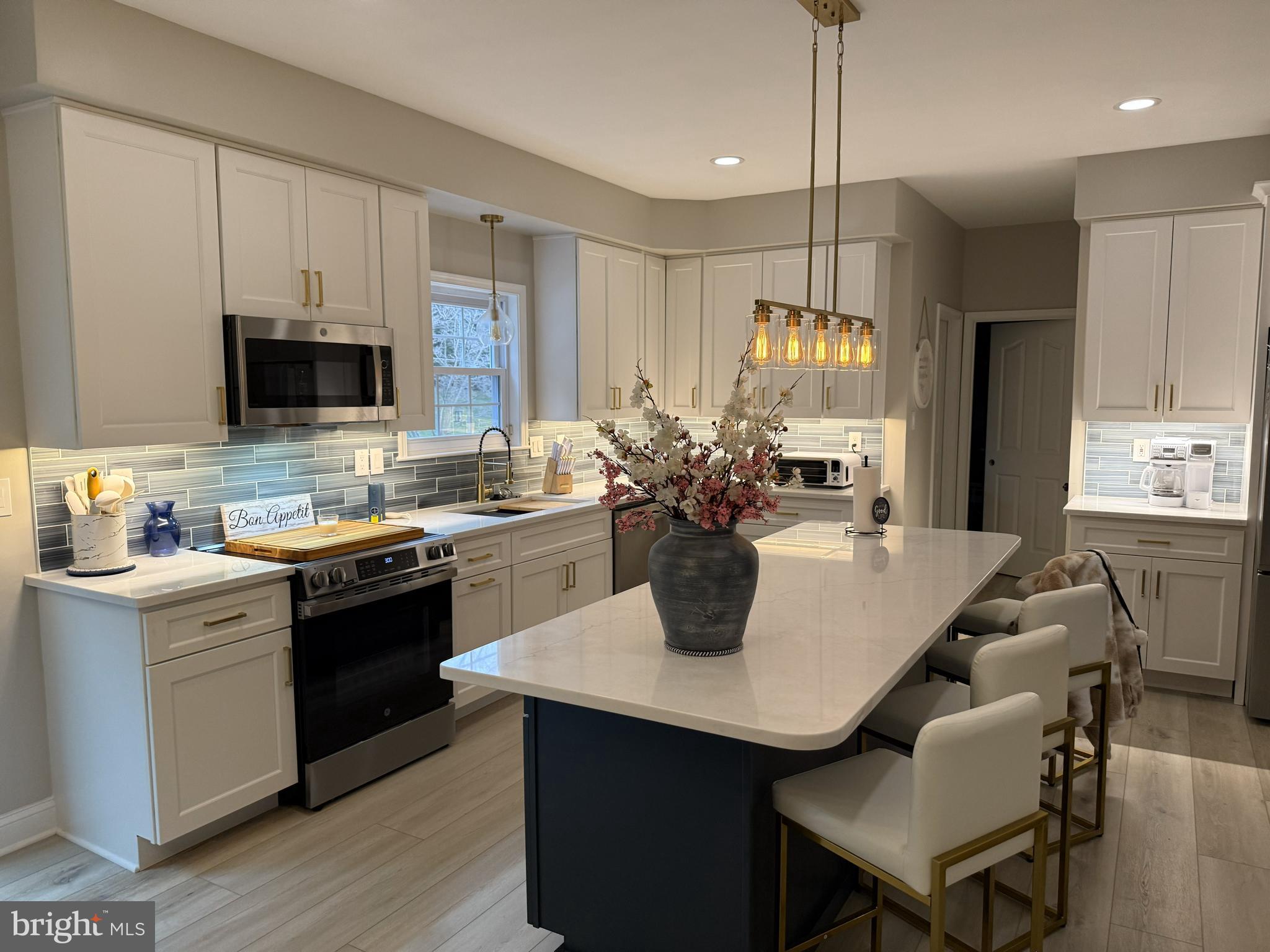 239 Heather Ridge Circle West Chester, PA 19382 - Photo 22 of 54 a kitchen with a stove a sink a dining table and chairs