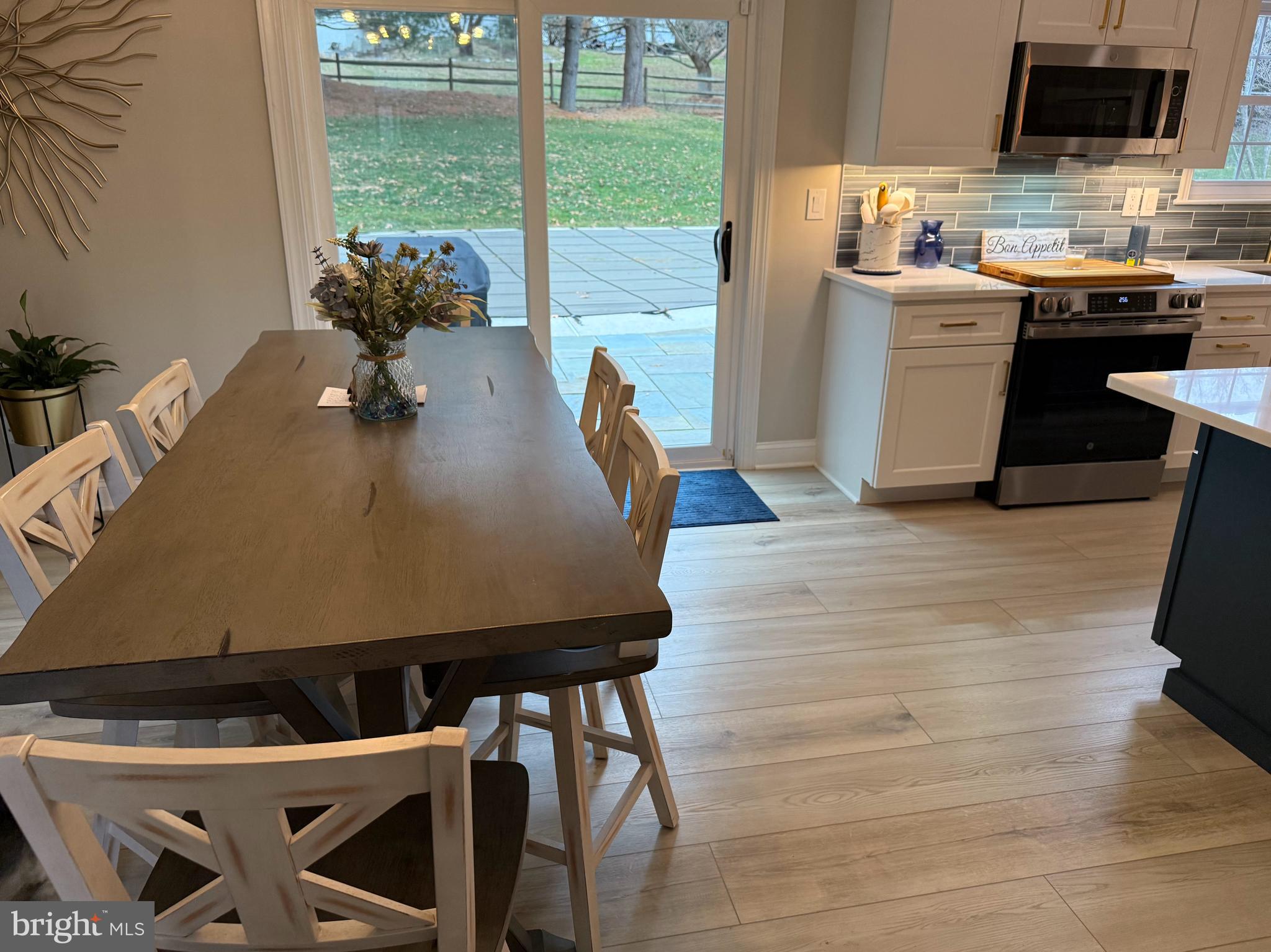 239 Heather Ridge Circle West Chester, PA 19382 - Photo 32 of 54 a kitchen with a table chairs and a stove