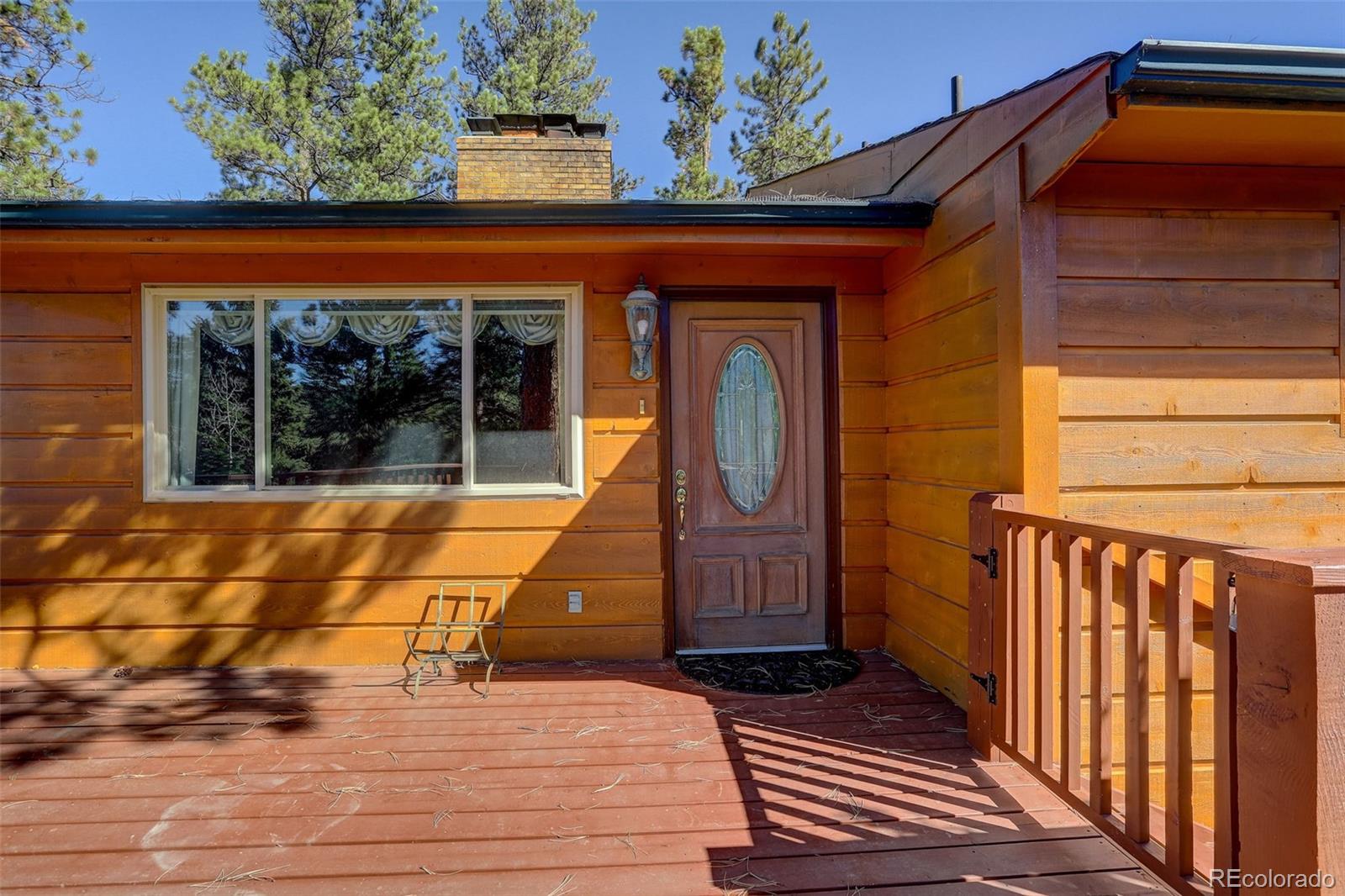 225 Spring Drive Pine, CO 80470 - Photo 13 of 44 a view of front door of house with wooden floor