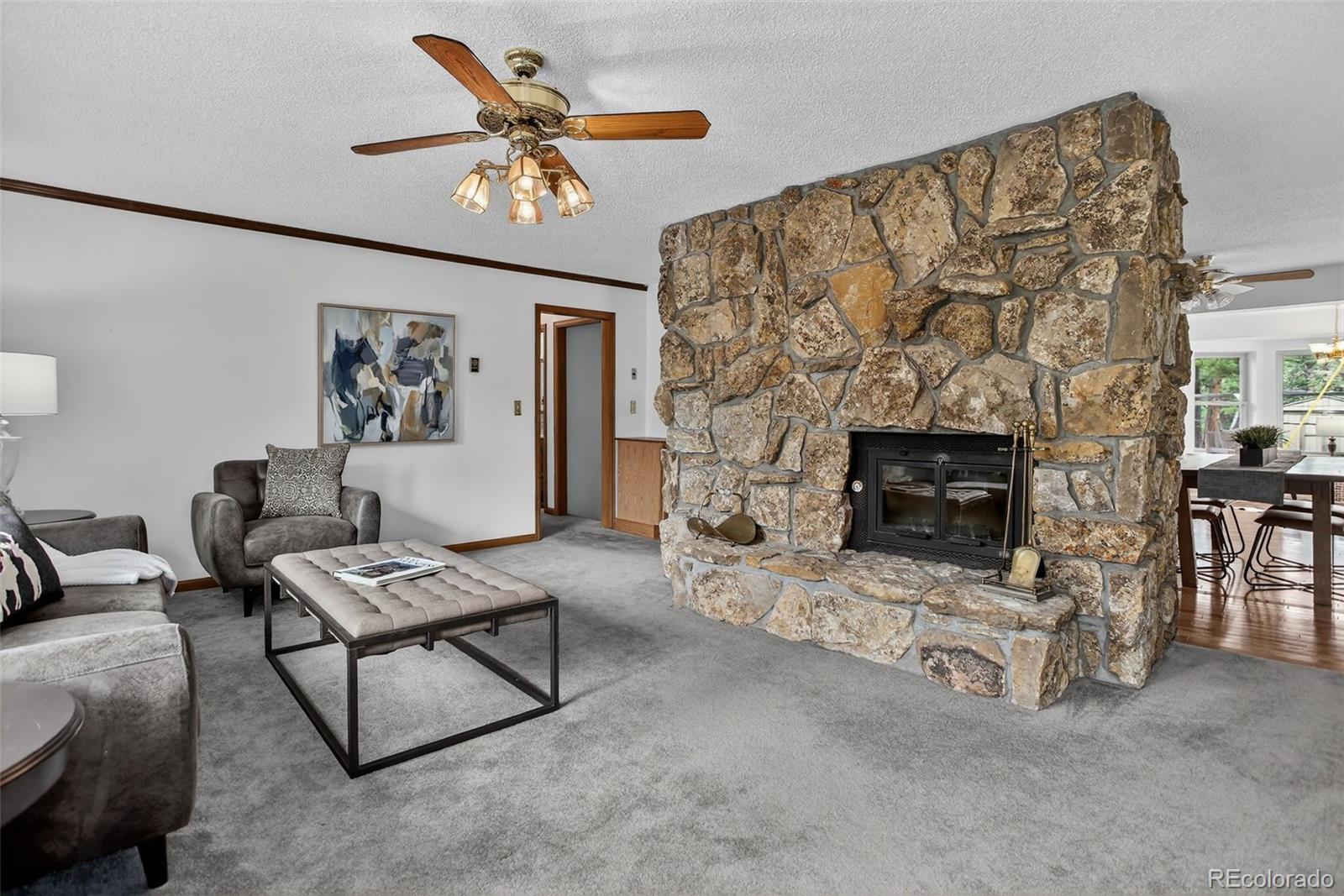 225 Spring Drive Pine, CO 80470 - Photo 18 of 44 a living room with furniture a chandelier and a fireplace