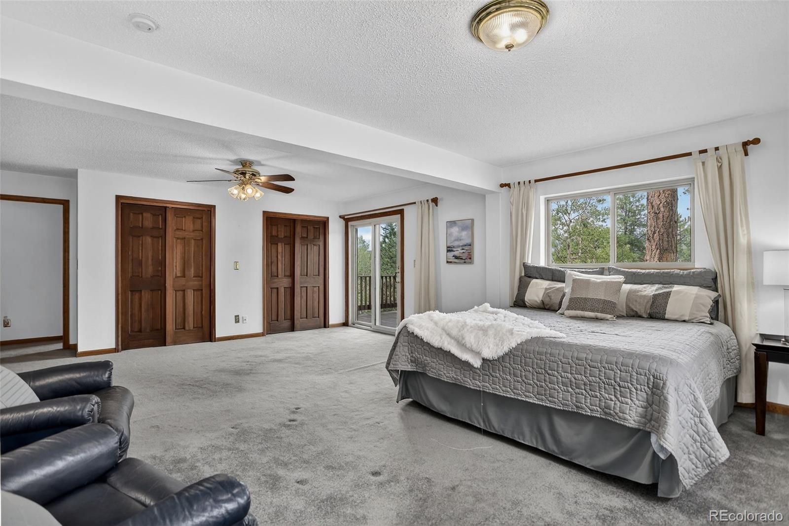 225 Spring Drive Pine, CO 80470 - Photo 19 of 44 a bedroom with a bed couch and window
