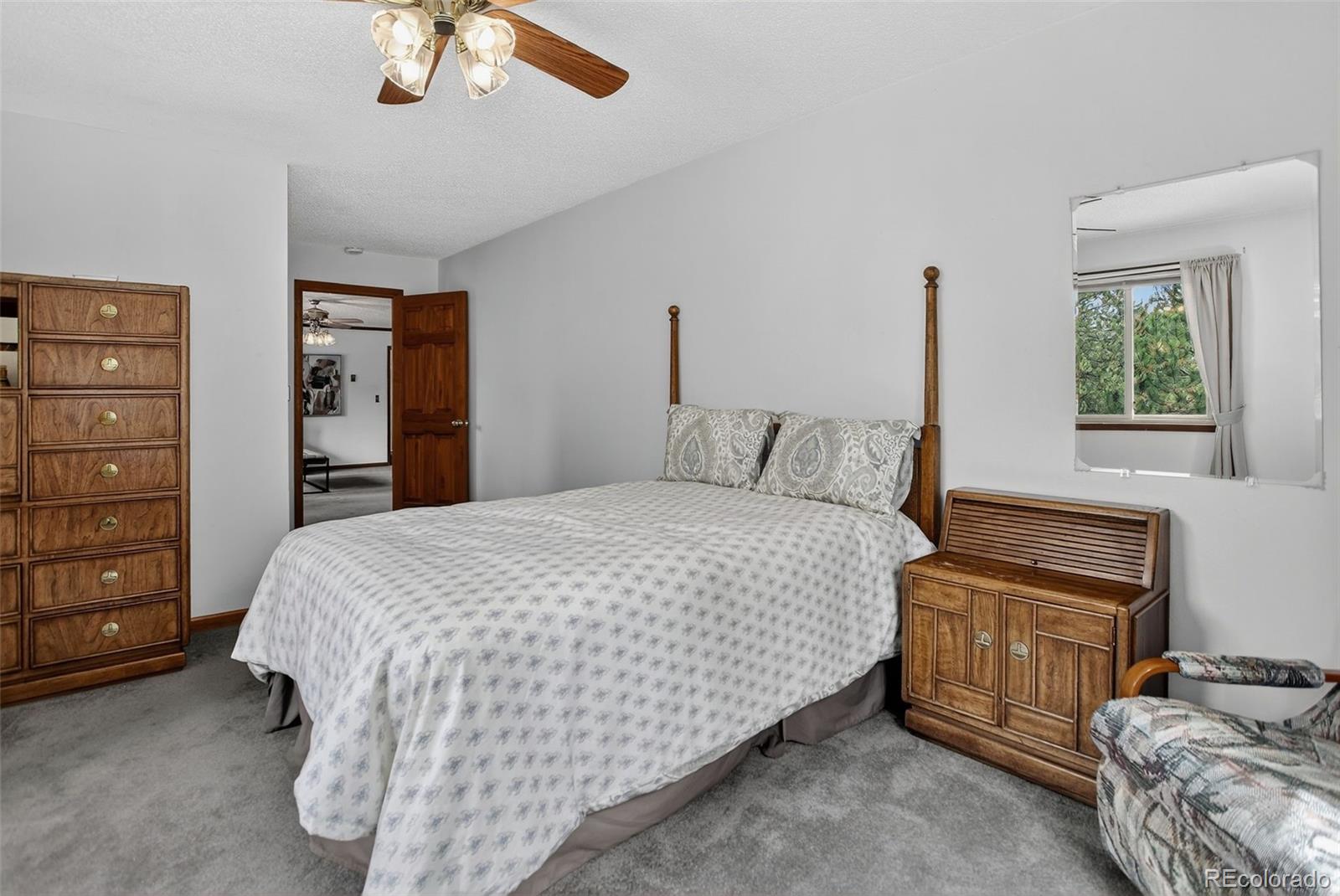 225 Spring Drive Pine, CO 80470 - Photo 20 of 44 a bedroom with a bed and a cabinets