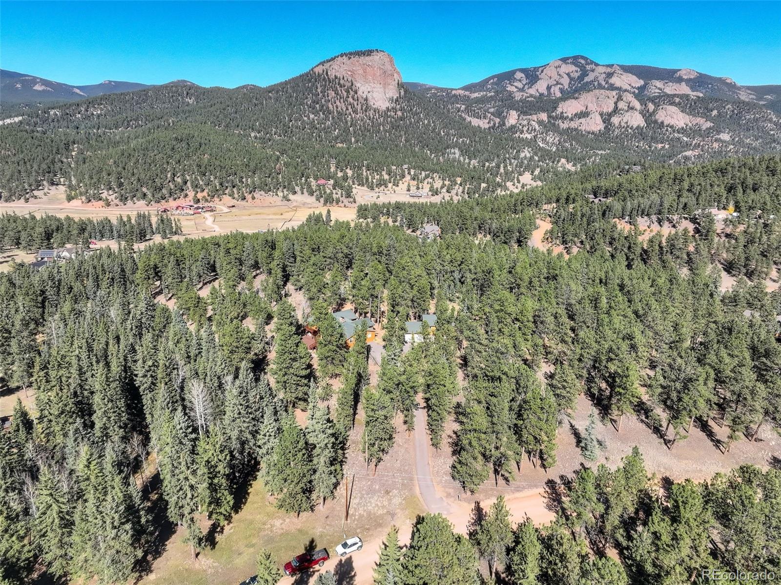 225 Spring Drive Pine, CO 80470 - Photo 25 of 44 a view of a field with a mountain in the background