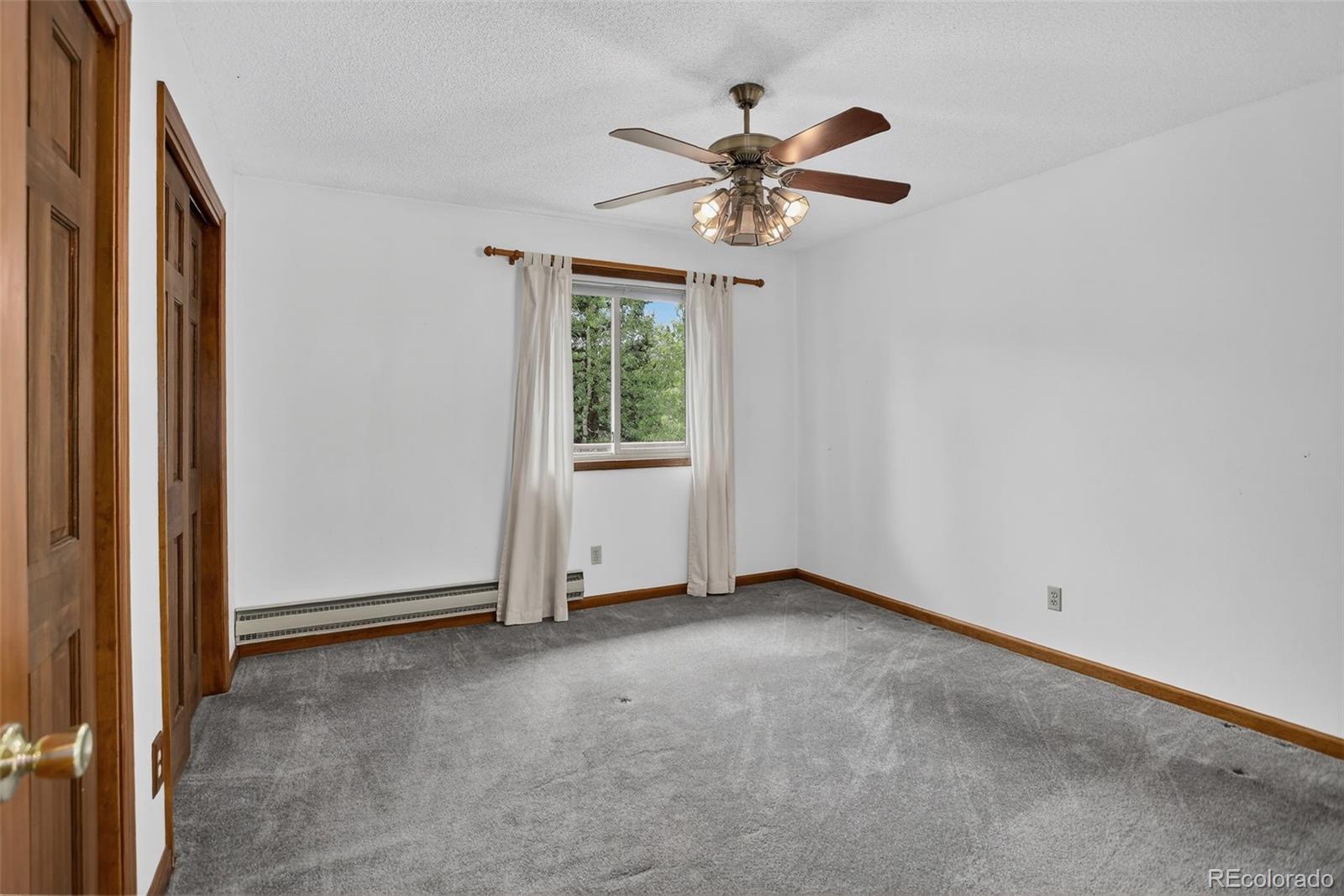 225 Spring Drive Pine, CO 80470 - Photo 29 of 44 an empty room with windows and fan