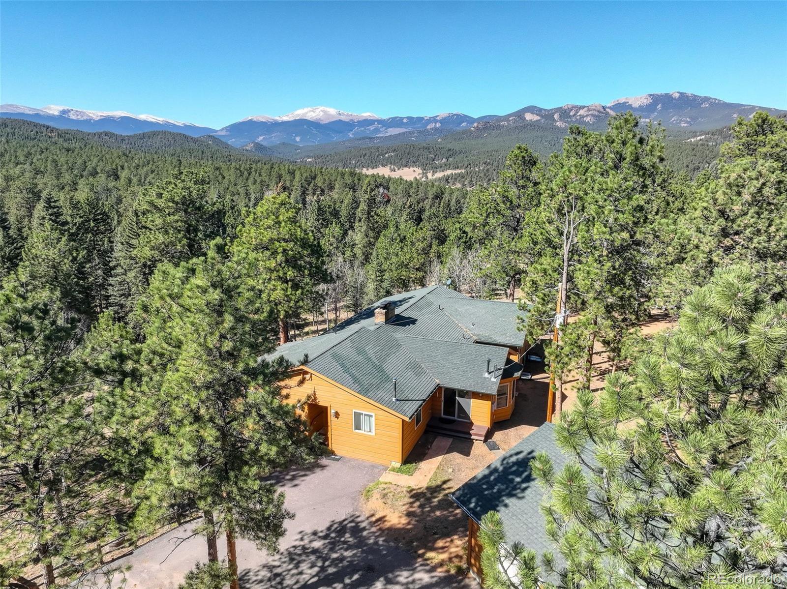225 Spring Drive Pine, CO 80470 - Photo 3 of 44 an aerial view of a house with a yard