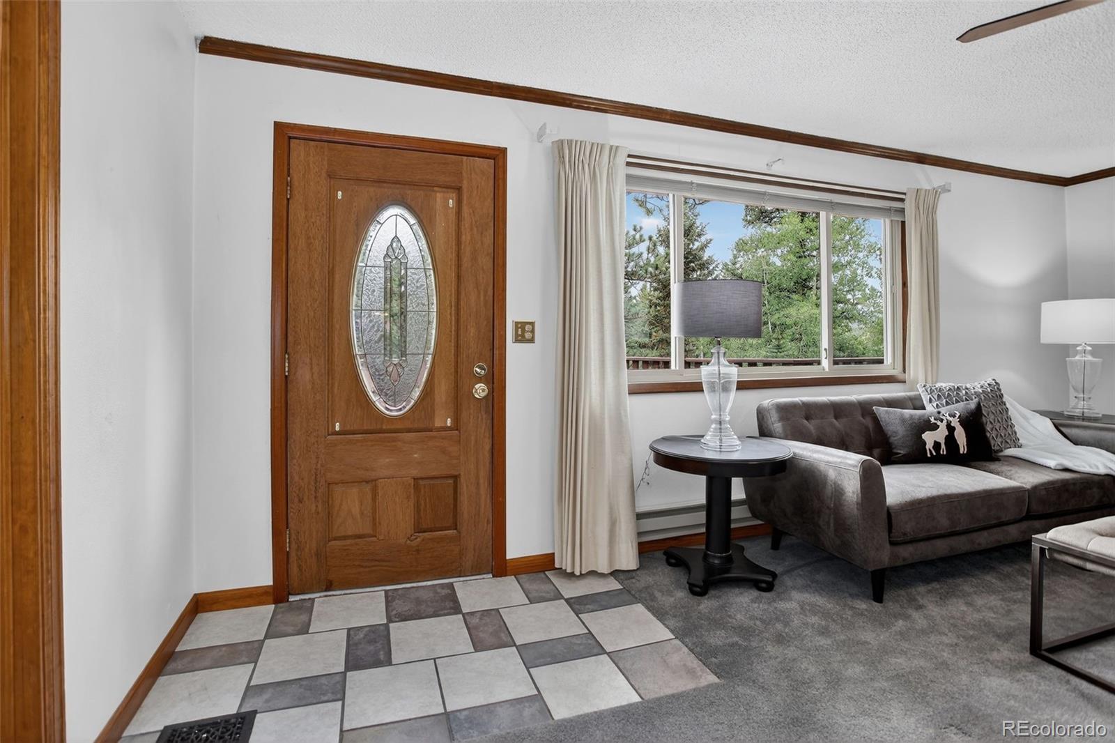225 Spring Drive Pine, CO 80470 - Photo 31 of 44 a living room with furniture and a window