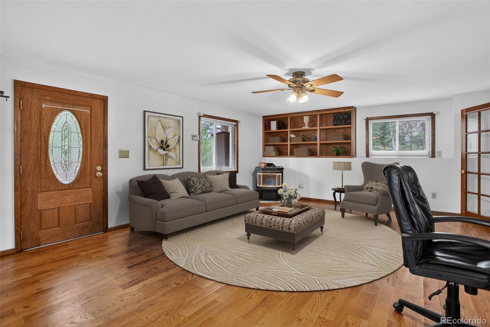 225 Spring Drive Pine, CO 80470 - Photo 32 of 44 a living room with furniture a large window and a chandelier