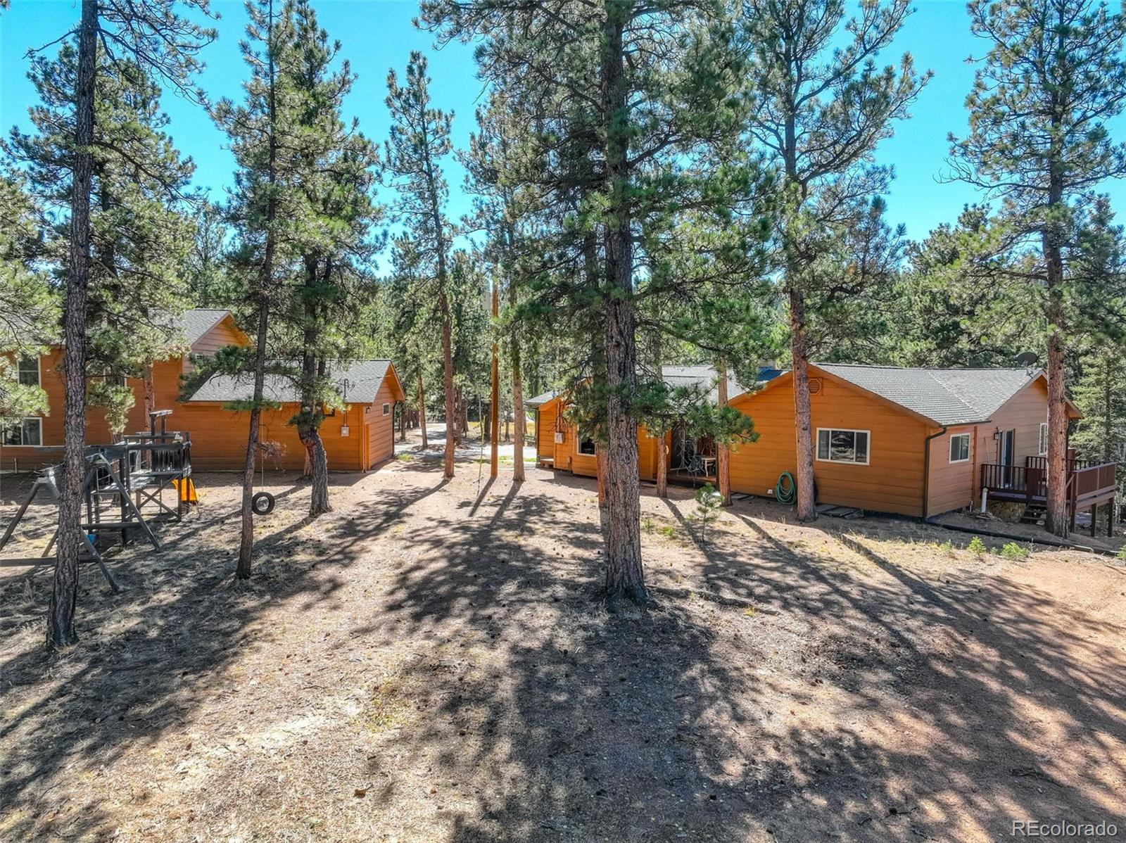 225 Spring Drive Pine, CO 80470 - Photo 38 of 44 a front view of a house with a yard