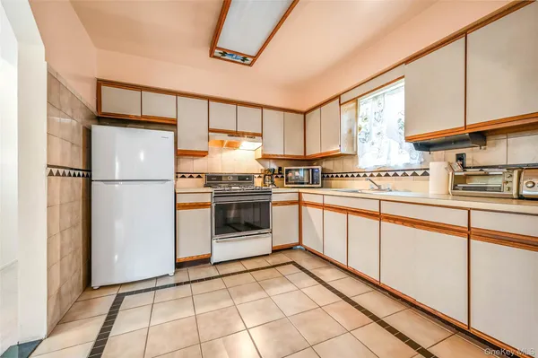 a kitchen with stainless steel appliances a refrigerator sink and cabinets