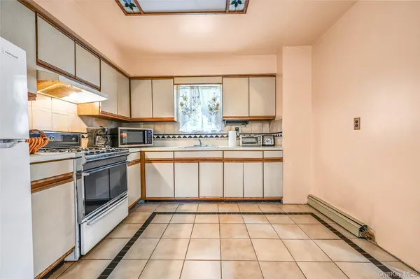 a kitchen with a stove a sink and a refrigerator