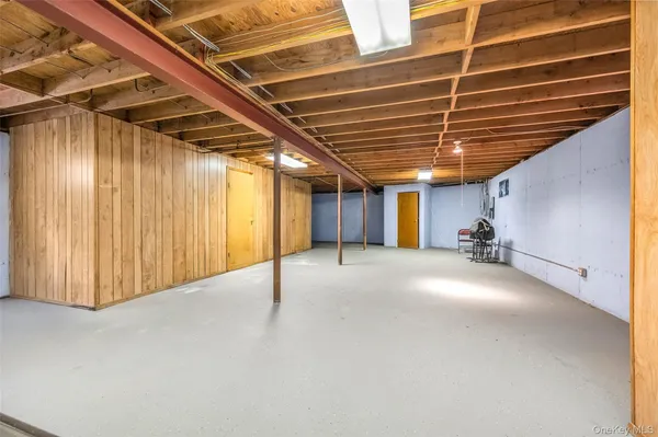 a view of empty room with wooden walls