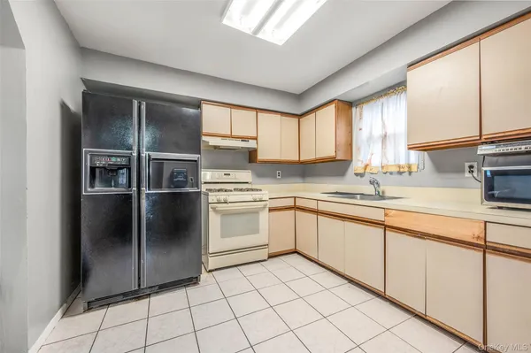 a kitchen with a sink window and cabinets