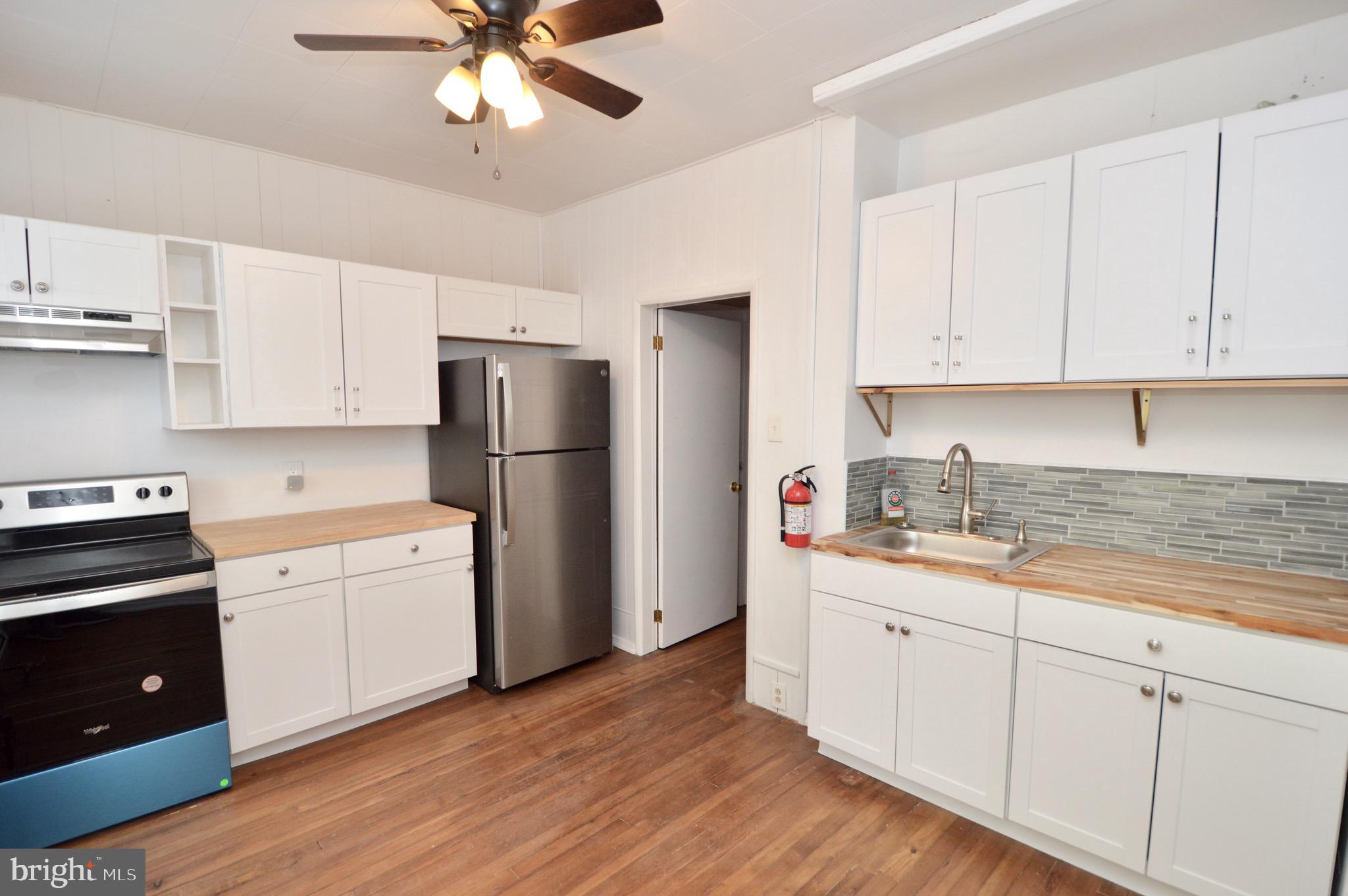 609 White Horse Pike Haddon Township, NJ 08107 - Photo 11 of 17 a kitchen with white cabinets white stainless steel appliances and sink