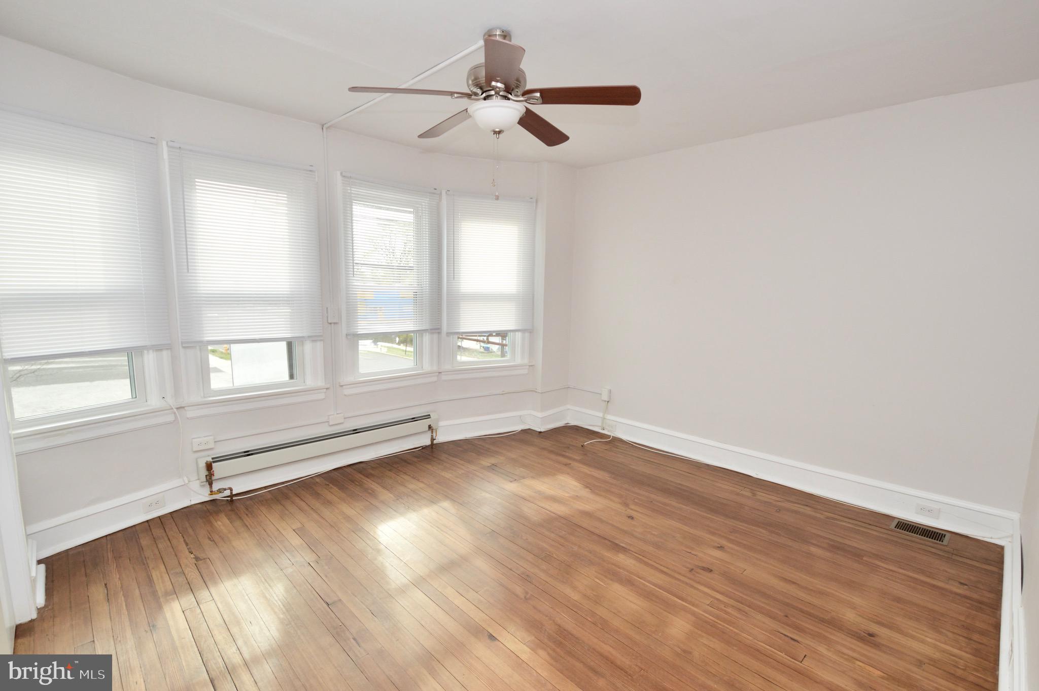 609 White Horse Pike Haddon Township, NJ 08107 - Photo 13 of 17 wooden floor in an empty room with a window