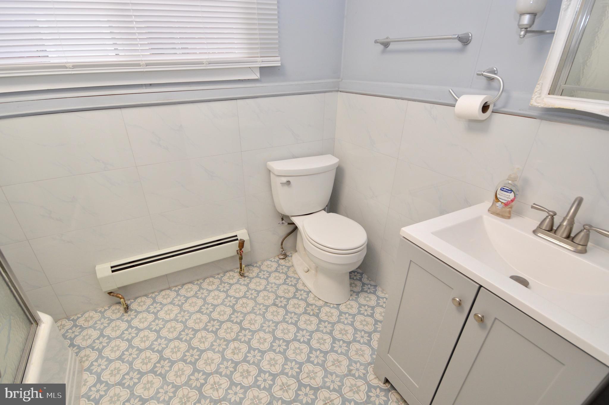 609 White Horse Pike Haddon Township, NJ 08107 - Photo 15 of 17 a bathroom with a sink a toilet and a mirror