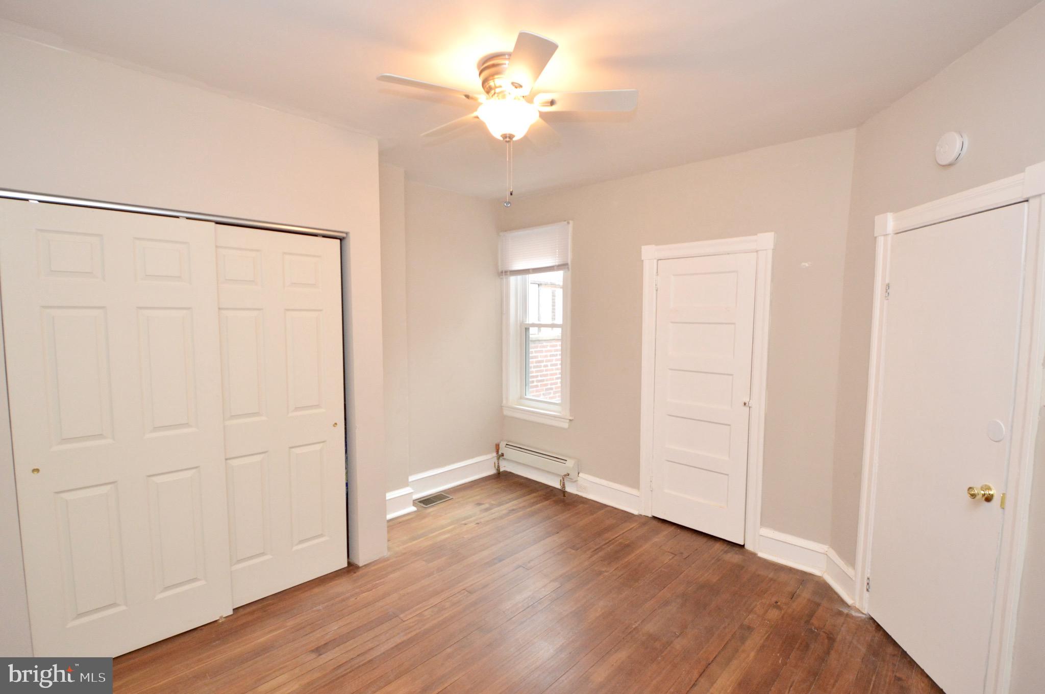 609 White Horse Pike Haddon Township, NJ 08107 - Photo 17 of 17 an empty room with wooden floor and a ceiling fan