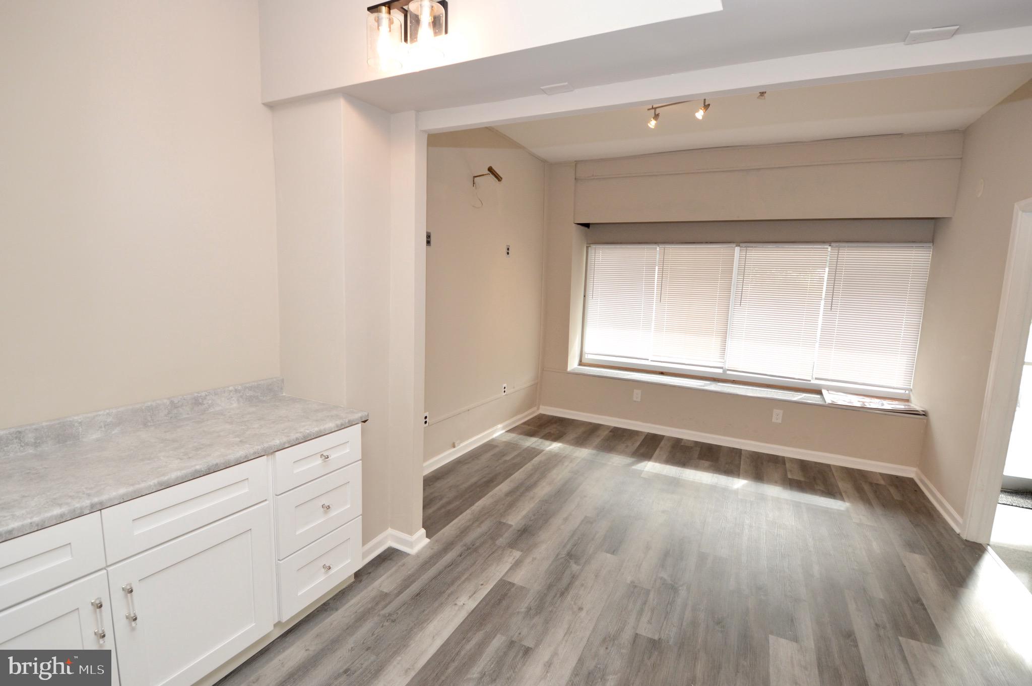609 White Horse Pike Haddon Township, NJ 08107 - Photo 4 of 17 a view of empty room with wooden floor and fan
