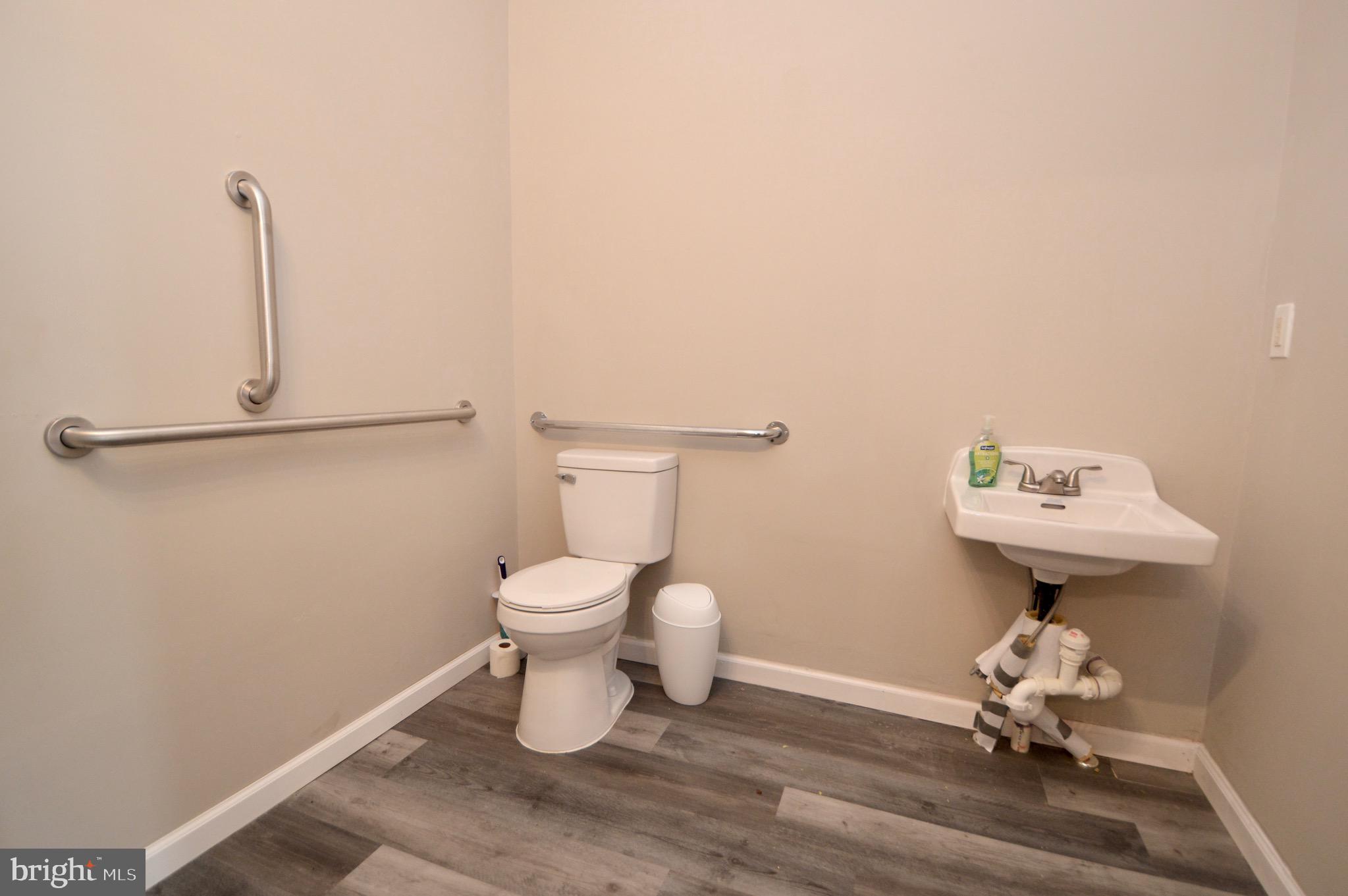 609 White Horse Pike Haddon Township, NJ 08107 - Photo 6 of 17 a bathroom with a sink toilet and a mirror