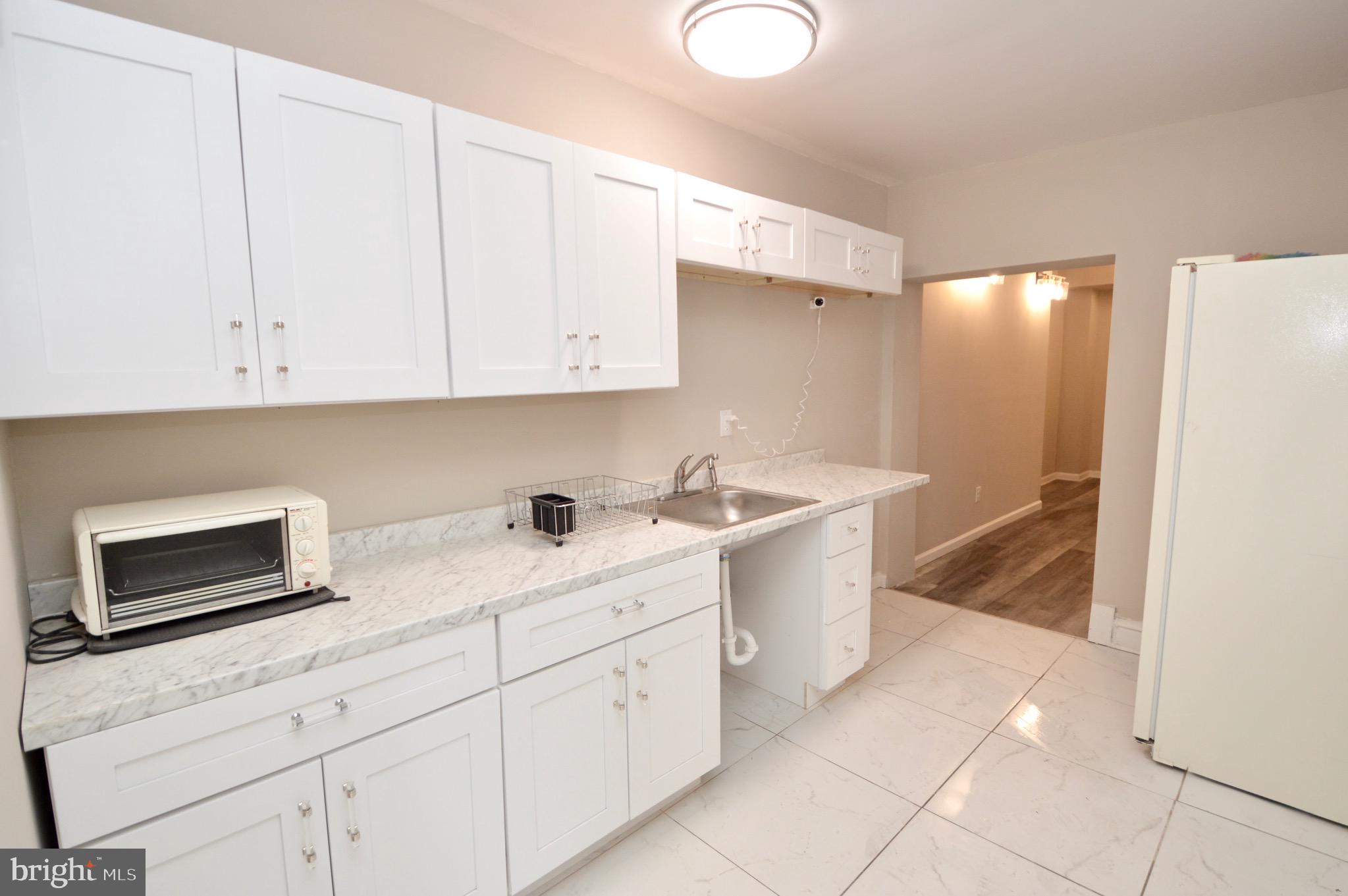 609 White Horse Pike Haddon Township, NJ 08107 - Photo 9 of 17 a kitchen with a sink and cabinets