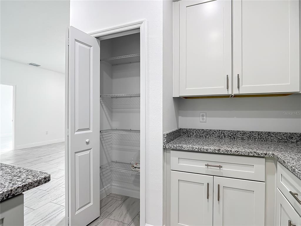 5736 North Claremont Drive Citrus Springs, FL 34434 - Photo 15 of 45 a kitchen with granite countertop white cabinets and a stove