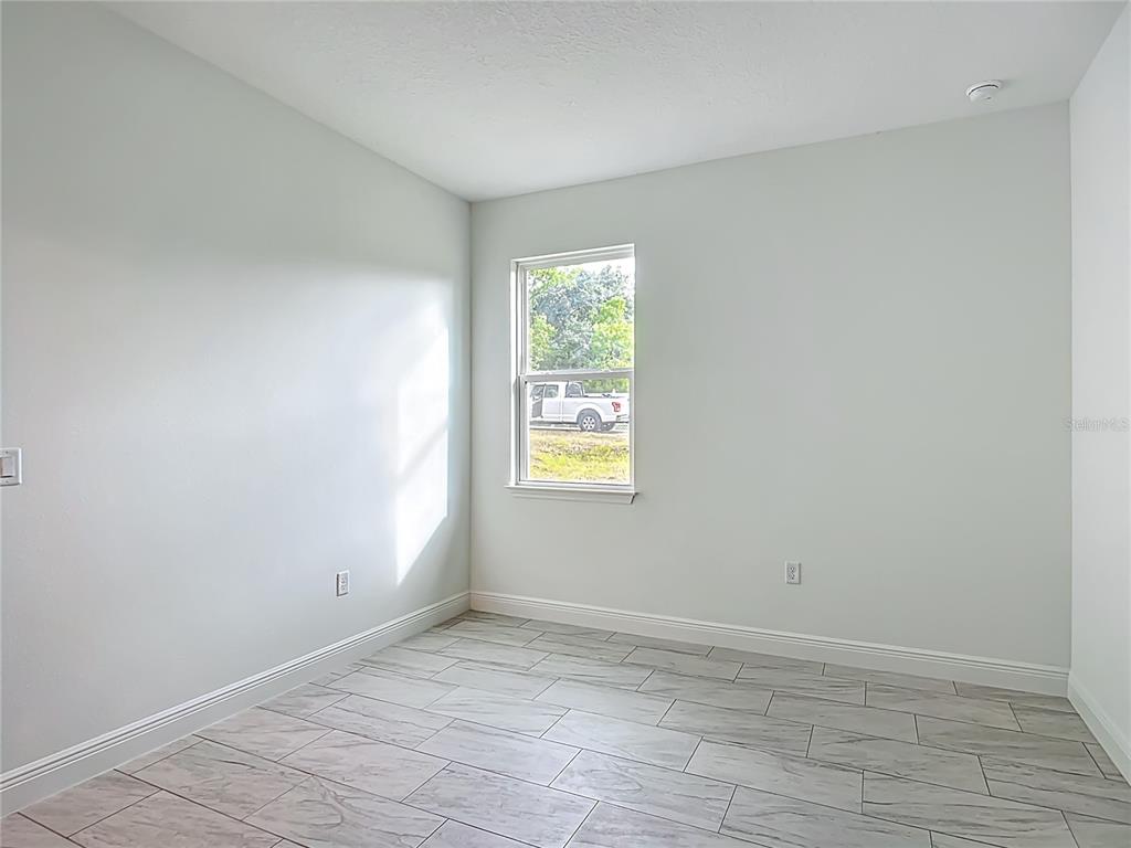 5736 North Claremont Drive Citrus Springs, FL 34434 - Photo 21 of 45 wooden floor in an empty room with a window