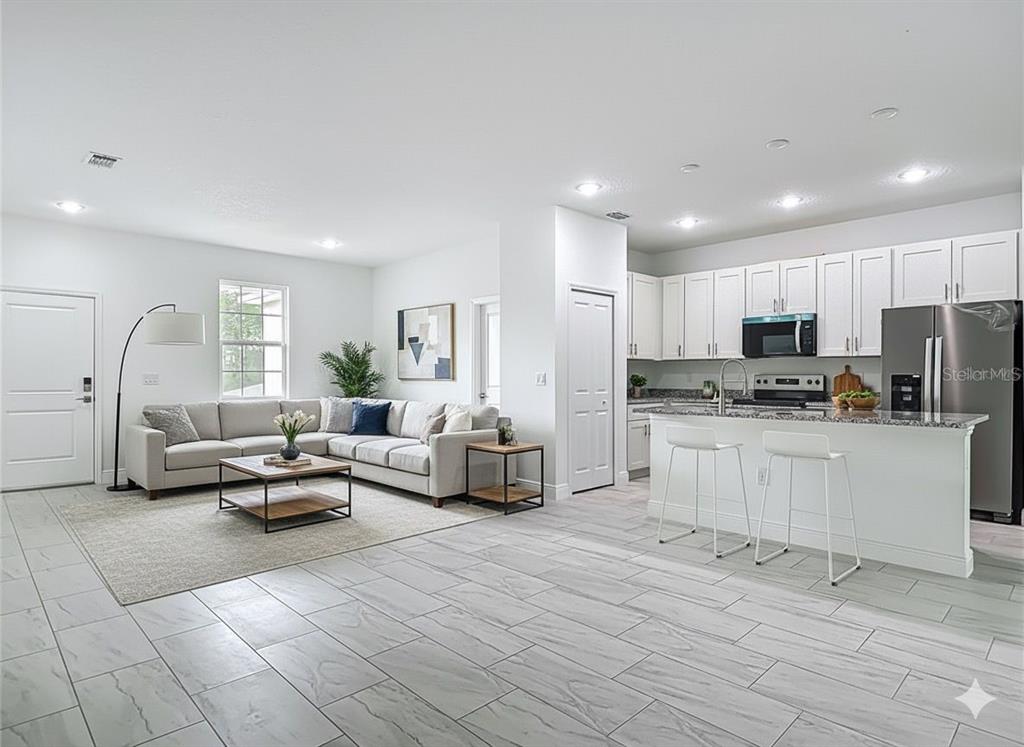 5736 North Claremont Drive Citrus Springs, FL 34434 - Photo 3 of 45 a living room with furniture and kitchen view