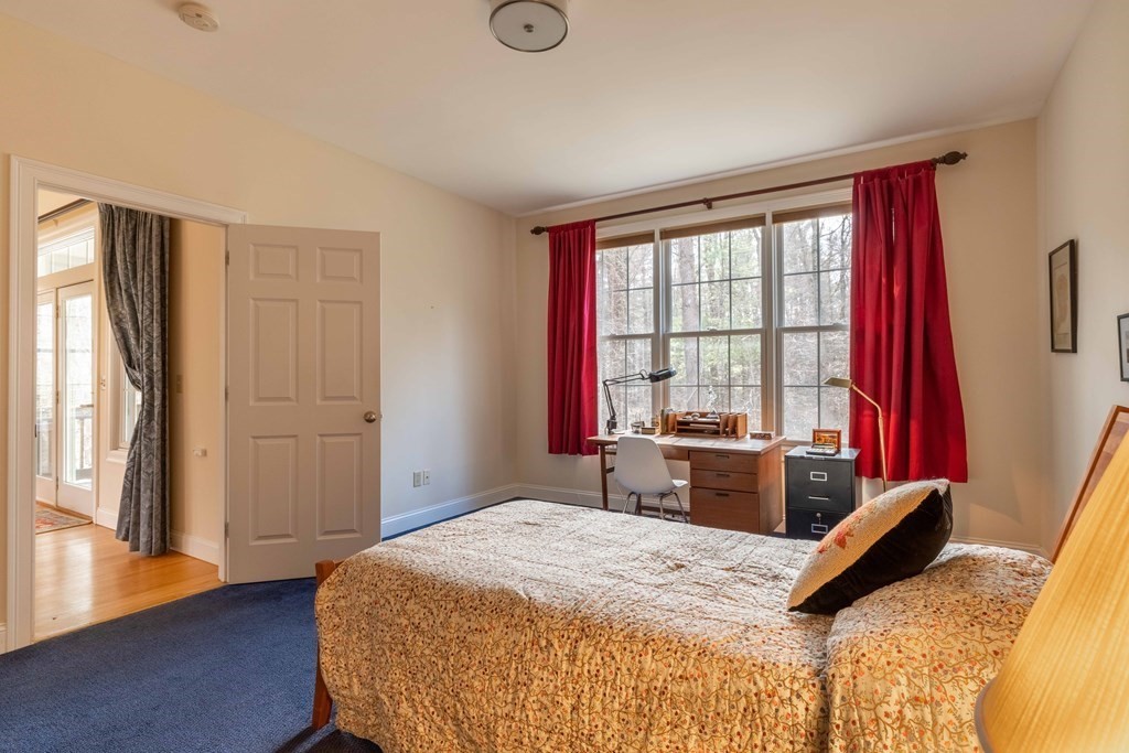 359 Main Street, Unit 15A Easthampton, MA 01027 - Photo 13 of 24 a bed sitting in a bedroom next to a window