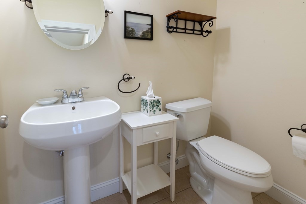 359 Main Street, Unit 15A Easthampton, MA 01027 - Photo 14 of 24 a bathroom with a sink a mirror and a toilet