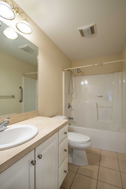 359 Main Street, Unit 15A Easthampton, MA 01027 - Photo 19 of 24 a bathroom with a sink a toilet and shower
