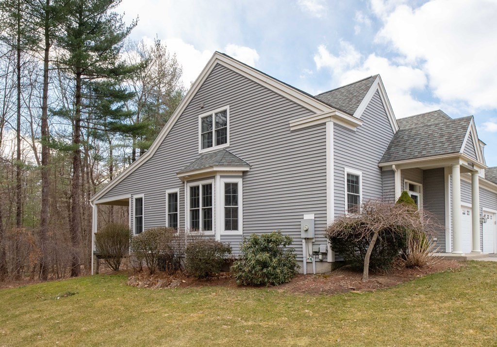359 Main Street, Unit 15A Easthampton, MA 01027 - Photo 2 of 24 a view of a house with a yard and lawn chairs with plants
