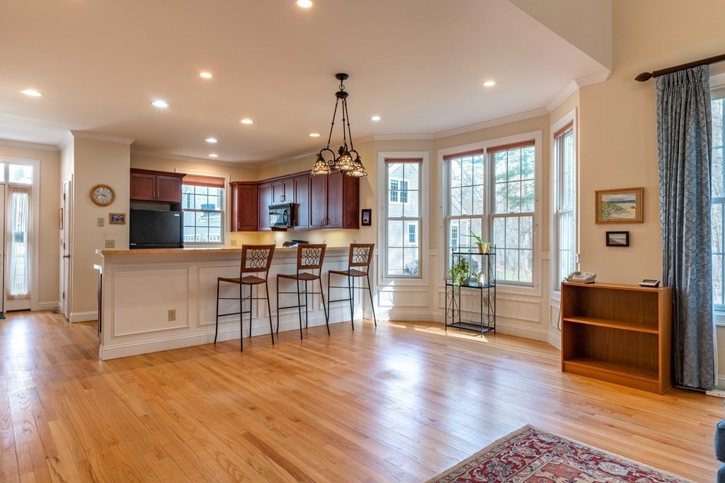 359 Main Street, Unit 15A Easthampton, MA 01027 - Photo 3 of 24 a view of kitchen with stainless steel appliances granite countertop sink stove refrigerator and wooden floor