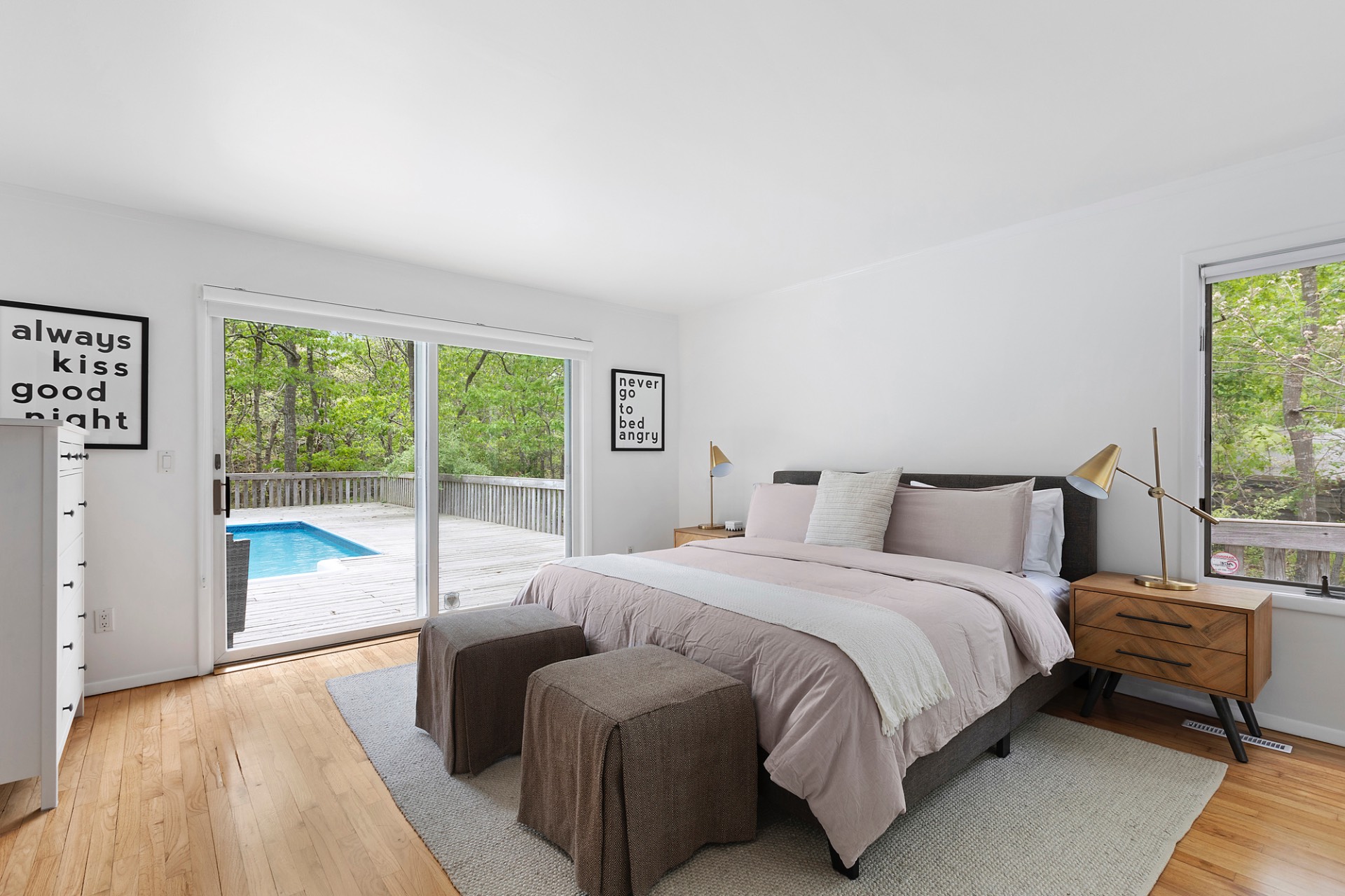 219 Town Line Road Wainscott, NY 11975 - Photo 11 of 19 a bedroom with a bed and a large window