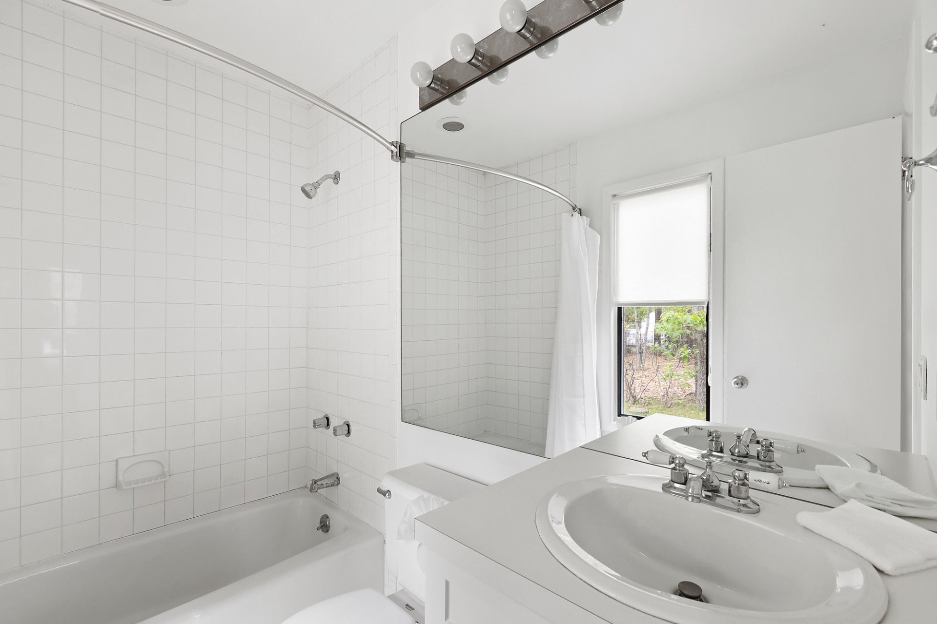 219 Town Line Road Wainscott, NY 11975 - Photo 14 of 19 a bathroom with a sink and a mirror