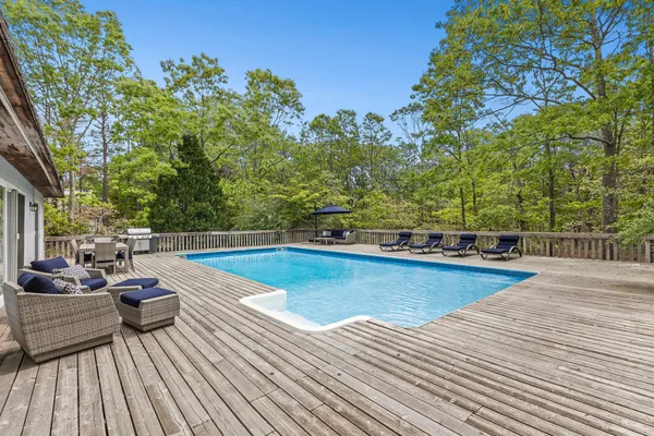 a view of a swimming pool with lounge chairs