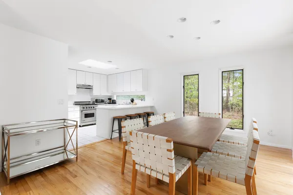 a living room with furniture and kitchen view
