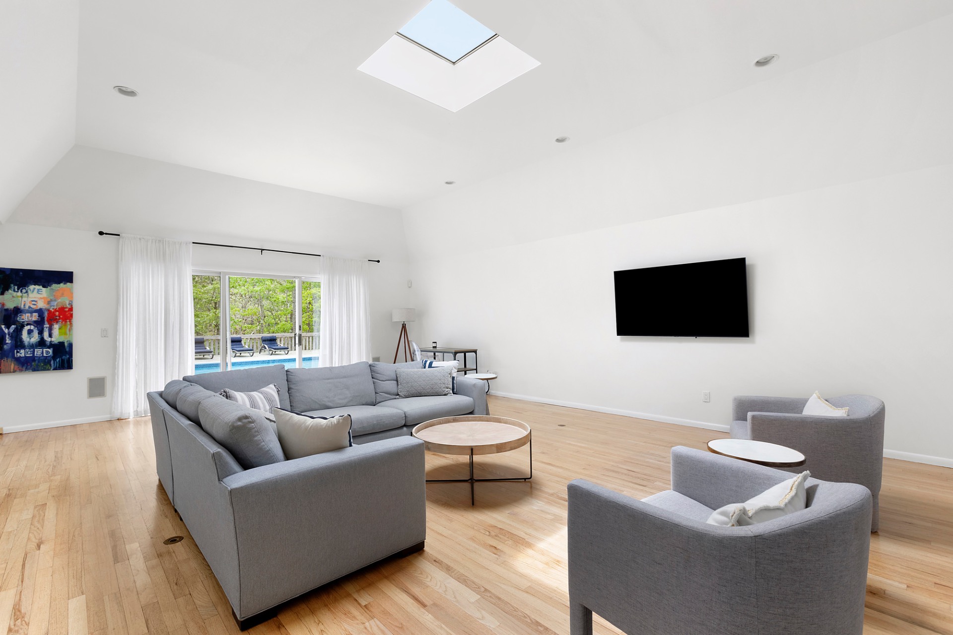 219 Town Line Road Wainscott, NY 11975 - Photo 7 of 19 a living room with furniture and a flat screen tv